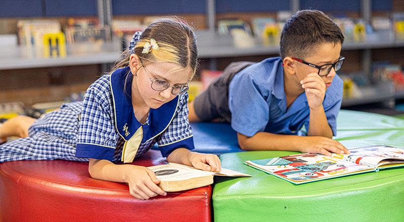 Boy and girl reading in St Mathew's Catholic Primary Windsor school library