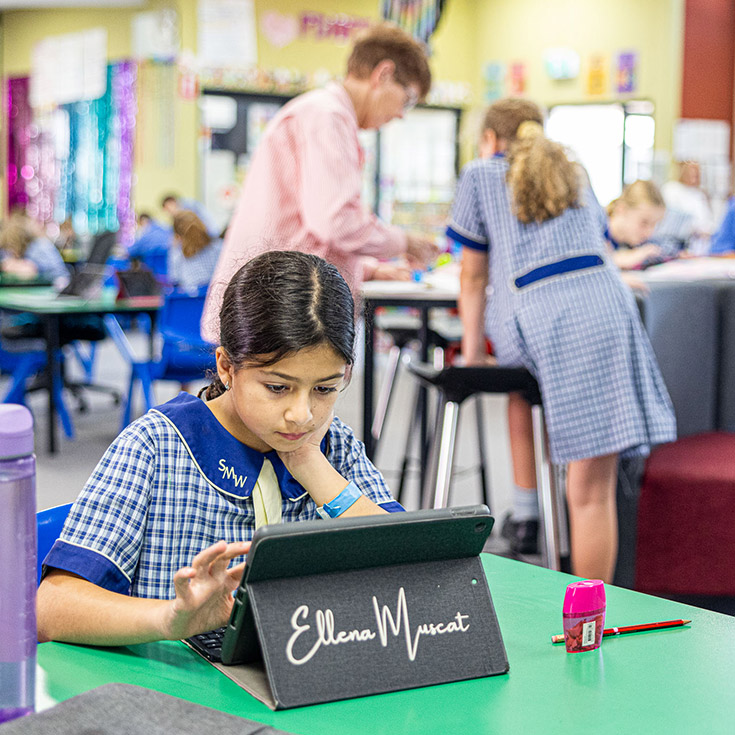 Girl on iPad at St Mathew's Catholic Primary Windsor